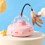 FurElite Smart UFO cat teaser toy in Cherry Blossom Powder pink color, on display stand, with feather wand and bell